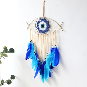 Evil Eye dream catcher wall decor with blue feathers and handmade crochet patterns