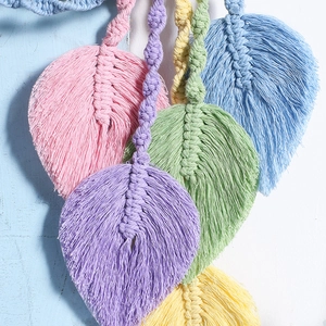 Macro shot of colorful handmade macrame cotton leaves with bohemian style woven textures