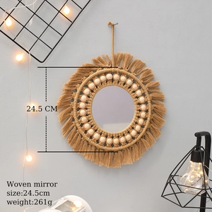 Detailed macro view of bohemian handmade macrame wall mirror with fringe and wood beads