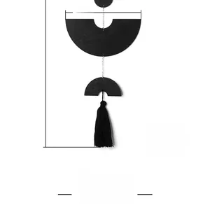Detail view of black geometric wall hanging with semi-circle disc and long tassel, 20x50cm