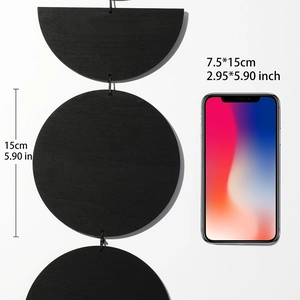 Detail showing the dimensions of the black wooden moon phase wall hanging with scale