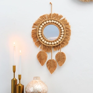 Detailed boho macrame wall mirror featuring yellow cotton ropes and leaf-shaped fringes
