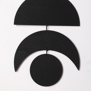 Minimalist black wooden moon phase wall hanging decor featuring geometric lunar shapes