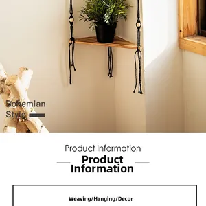 Detail of bohemian triangle wooden shelf with black woven rope and decorative tassels