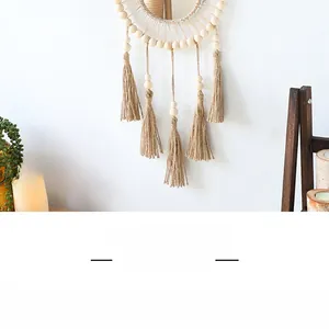 Detail of bohemian macrame wall hanging with wooden beads and long cotton fringe tassels
