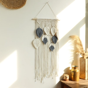 Boho hand-woven leaf macrame wall hanging in beige and grey cotton rope on wood branch