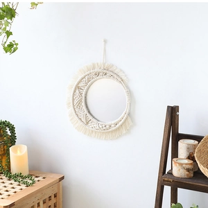 Detail of handmade macrame fringe and woven cotton rope texture on a boho wall mirror