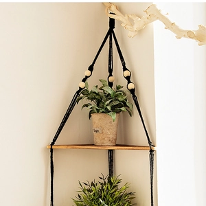 Hanging wooden corner shelf with black woven rope and wood beads for home decor