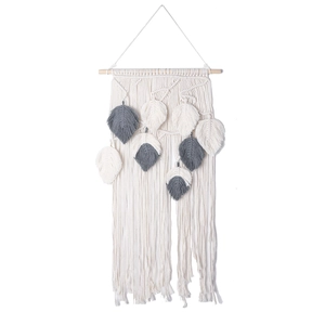 Detailed close-up of handmade macramé wall hanging with grey and cream cotton feathers