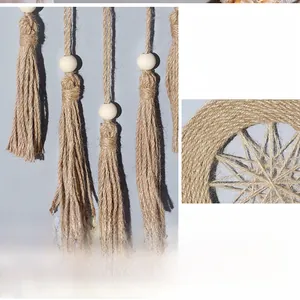 Macro shot of handmade woven wall hanging featuring cotton ropes and wooden beads detail
