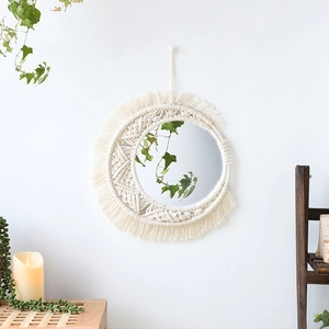 Detail of handmade bohemian woven cotton fringe around a circular wall mirror