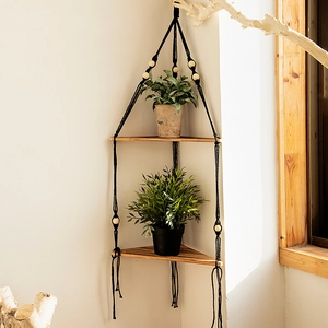 Detail of bohemian double-tier triangle wood wall shelf with handwoven black cotton rope