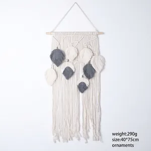 Handmade Bohemian woven wall tapestry featuring leaf patterns and solid wood bar