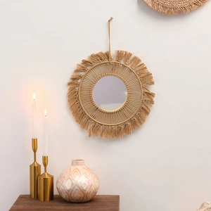 Close-up of bohemian wall mirror featuring handmade woven fringe and cotton rope detail