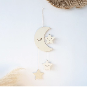 Detail of wooden crescent moon and stars wall hanging with cute smiling face carvings