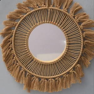 Detail of bohemian hand-woven wall mirror featuring coffee brown cotton cord and fringe