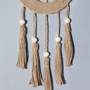 Handmade moon-shaped woven wall hanging with tassels and wooden beads in Nordic style