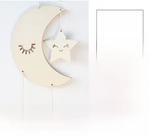 Detail of wooden moon and star wall hanging with carved smiley faces and white cords