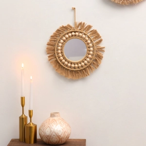 Close-up of Bohemian round wall mirror with handmade macrame fringe and wooden beads