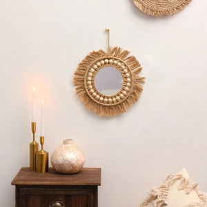 Detail of bohemian round macrame wall mirror with hand-woven cotton fringe and wooden beads