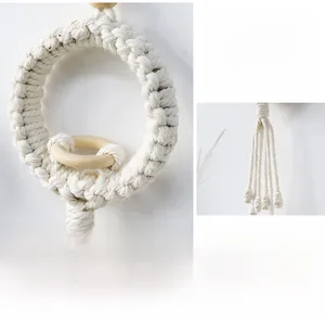 Close-up of bohemian handmade macrame wall hanging with cotton rope and wooden ring