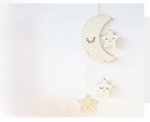 Detail of bohemian moon and stars wall hanging made of thick fabric with smiling faces