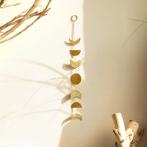 Boho sun and moon phase wall hanging with seven hammered golden metal discs on chains