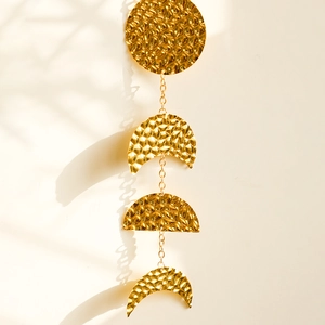 Bohemian gold moon phase wall hanging with hammered metal texture and delicate chains
