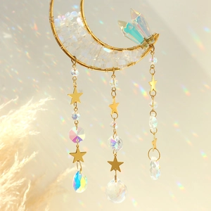 Detail of moon suncatcher with white crystals and golden pentagram star pendants