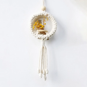 Bohemian handmade macrame wall hanging basket with yellow dried flowers and tassels