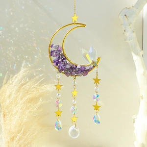 Golden moon suncatcher with amethyst stones and crystals creating colorful light reflections