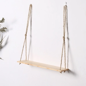 Close-up of minimalist wooden wall shelf with natural jute rope and polished board
