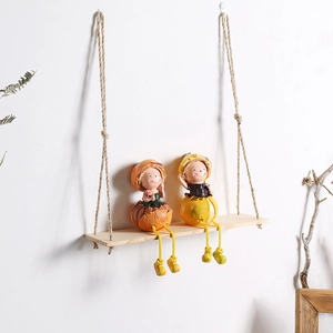 Bohemian hanging shelf with cute fruit-style dolls on a wooden swing wall decor