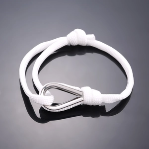 White braided rope bracelet with silver horseshoe shackle, minimalist nautical style