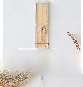 Detail showing dimensions of bohemian wood wall decor with braided cotton rope accents