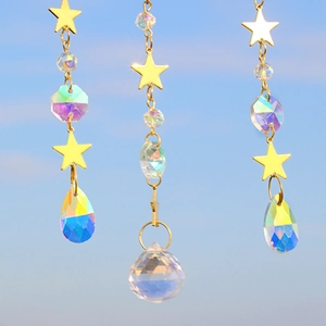 Detail of crystal suncatcher featuring golden stars and iridescent multifaceted teardrop beads