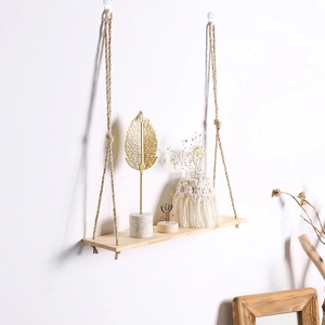 Close-up of bohemian wooden floating shelf with hand-woven hemp rope for wall plants