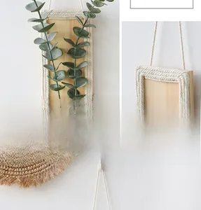 Detail of bohemian wall decor featuring woven cotton rope on a rectangular wood board