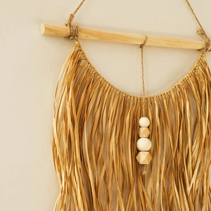 Bohemian handmade raffia wall hanging with wooden beads and natural wood rod