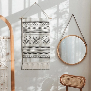 Bohemian handwoven wall hanging tapestry with black geometric patterns and tassels