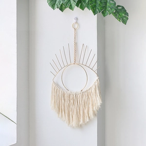 Bohemian evil eye wall hanging with golden metal frame and macrame cotton tassels