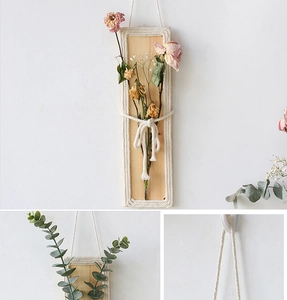 Detail of bohemian wood wall decor featuring handmade rope weaving and dried flowers