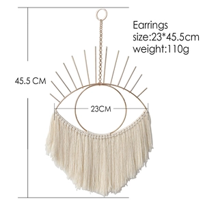 Bohemian gold metal evil eye wall hanging with white cotton tassels and size markings