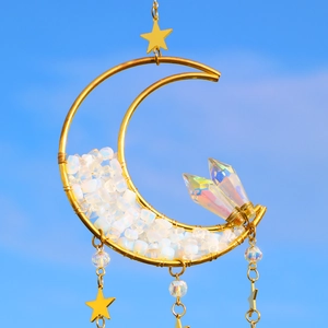 Detailed view of handmade moon suncatcher with opal stones and golden wire wrap
