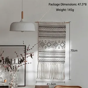 Bohemian hand-woven wall tapestry with black geometric patterns and long white fringe