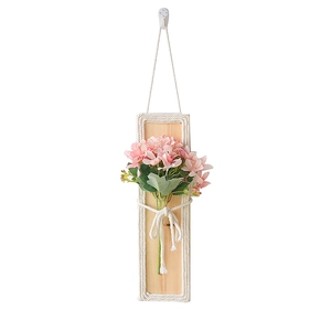 Bohemian wooden wall hanging decor with pink faux flowers and woven cotton rope