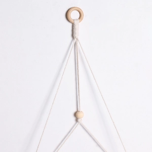 Detail of bohemian cotton rope weave with wooden ring and natural decorative beads