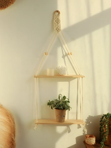 Detail of bohemian hand-woven cotton rope shelf with double wood layers and wooden beads