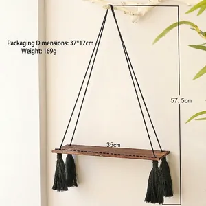 Detail view of Bohemian wall hanging shelf with black tassels and 35cm wood board