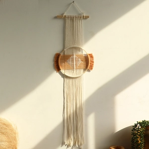 Detail of Boho hand-woven tapestry showing intricate cotton fiber patterns and wood pole